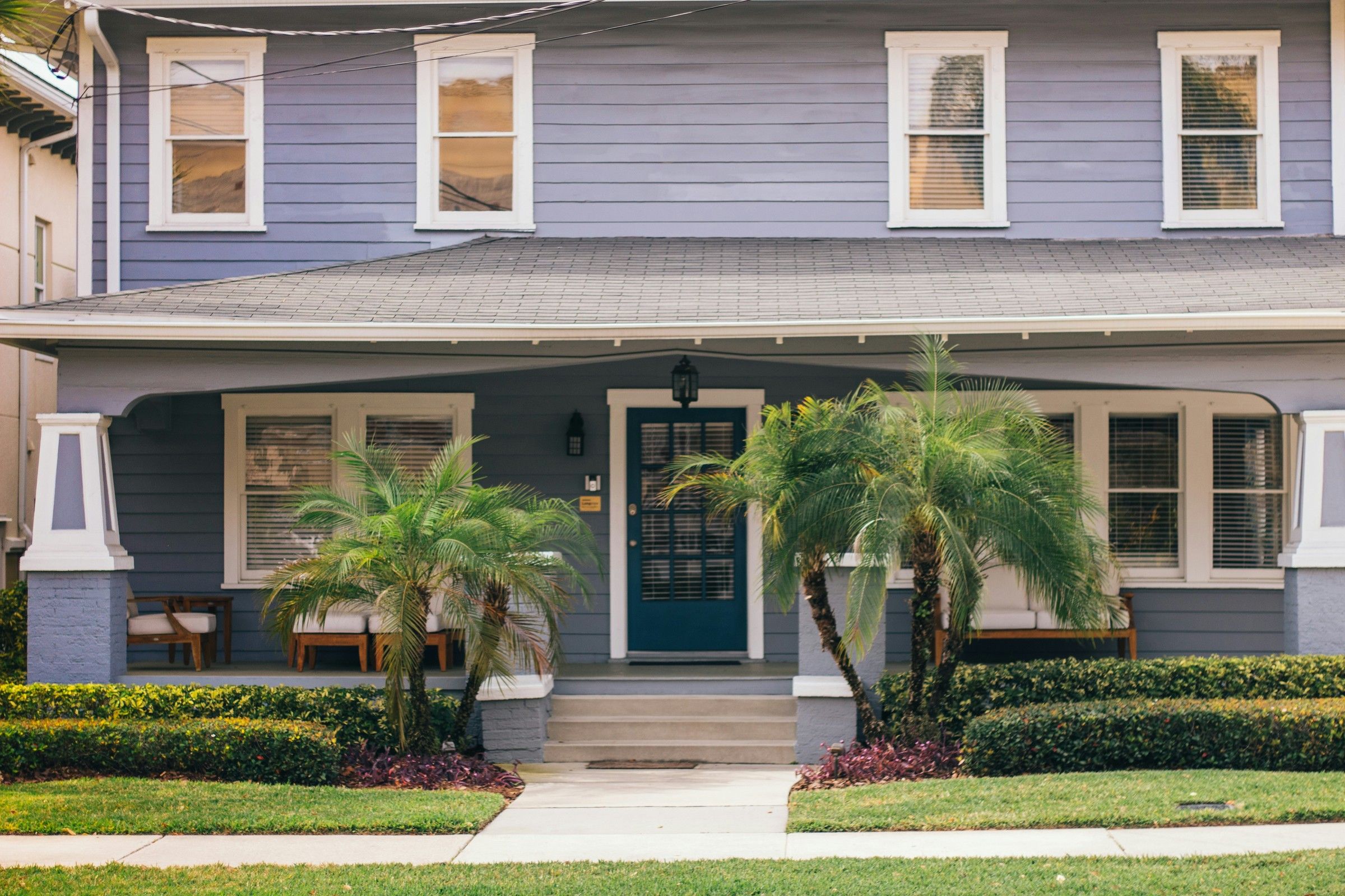 A friendly home with a front porch and palm trees